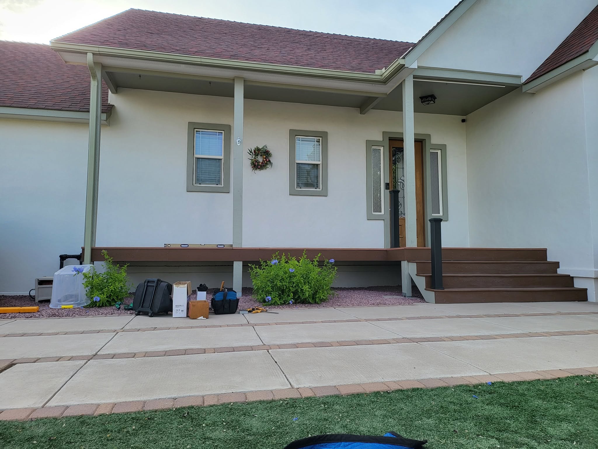 Finished porch with custom steel railing and stairs