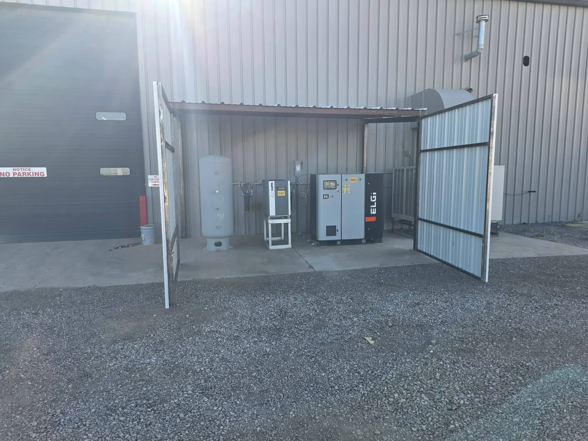 Completed equipment enclosure with steel doors open