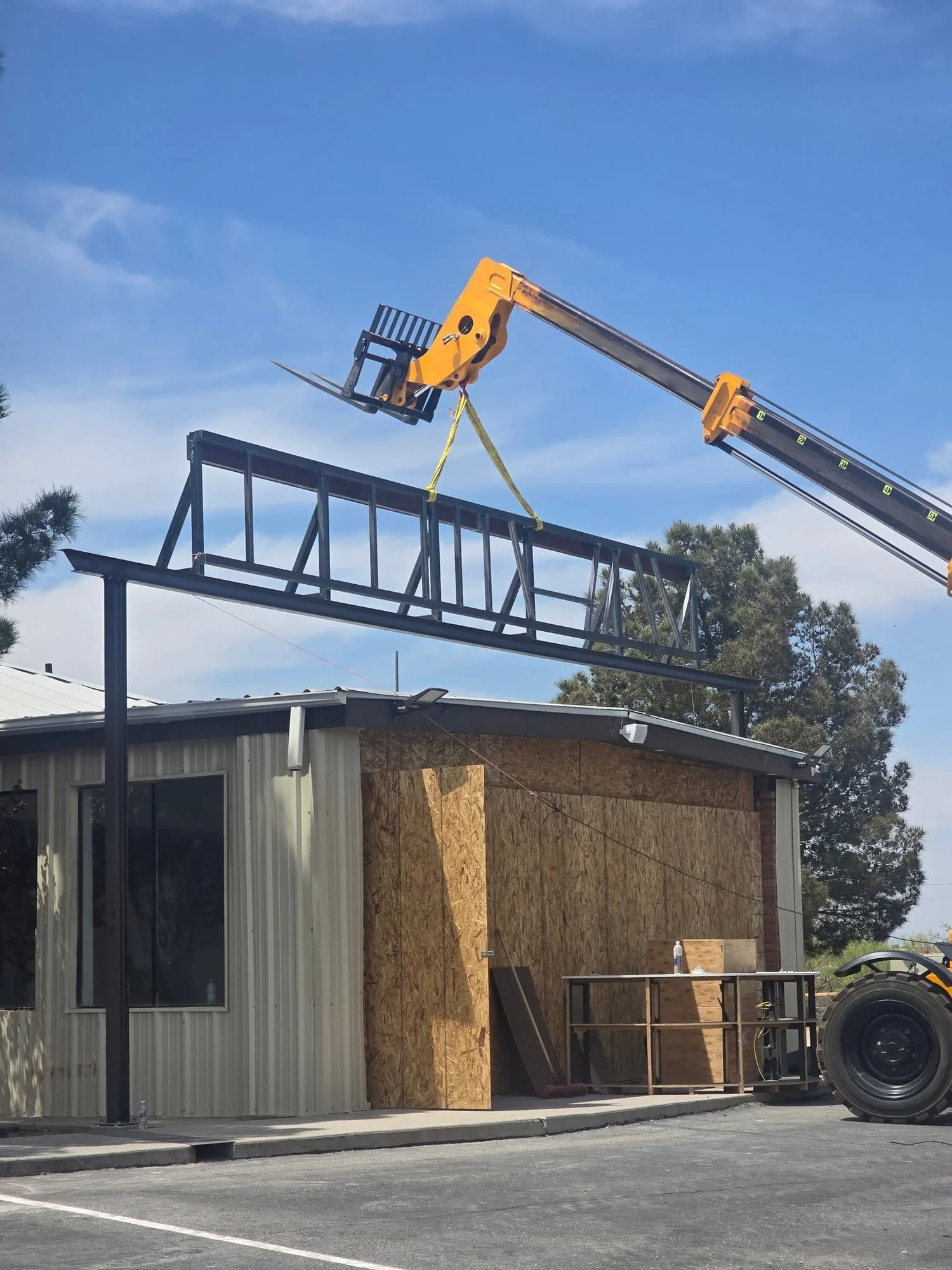 Steel roof frame being set on a local building