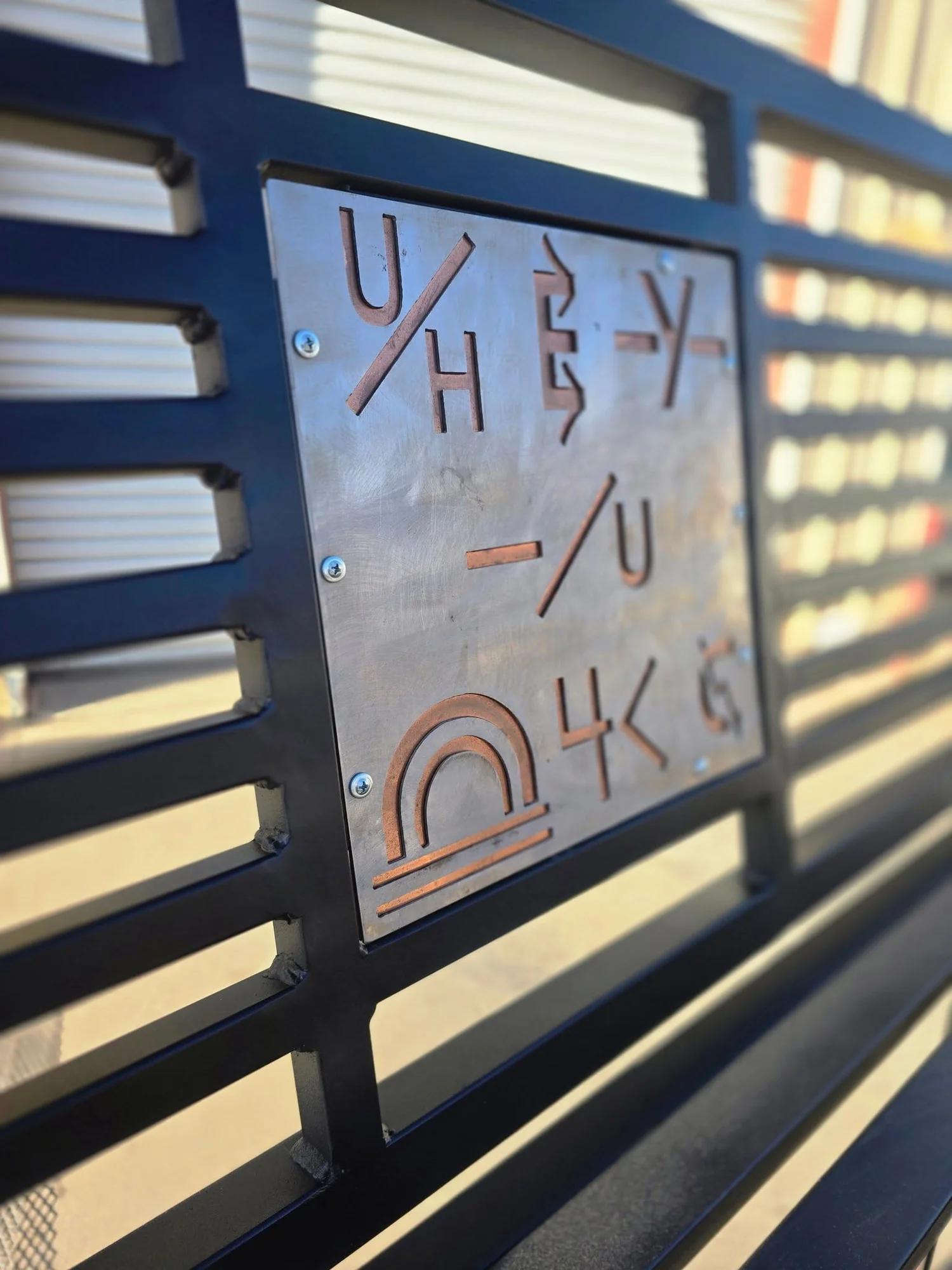 Custom decorative panel installed in a steel bench