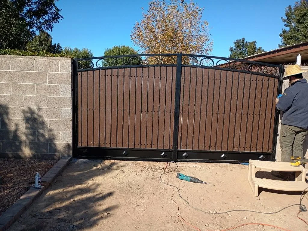 Double driveway gate with ornamental steel scrollwork